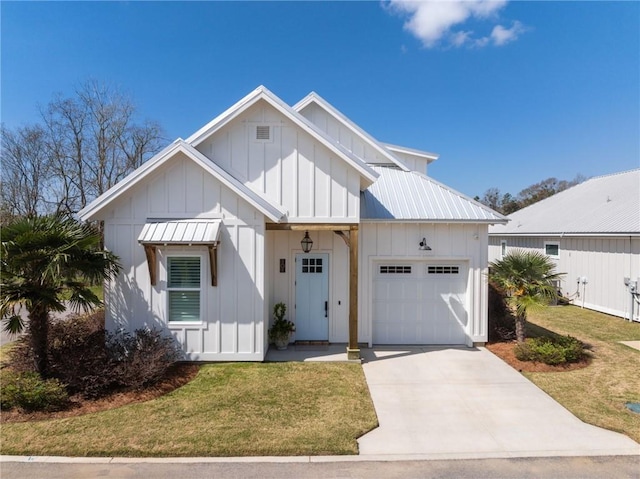 modern farmhouse style home featuring a front yard, board and batten siding, and an attached garage