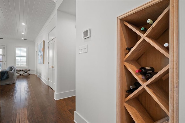 wine room featuring recessed lighting, dark wood-style floors, and baseboards