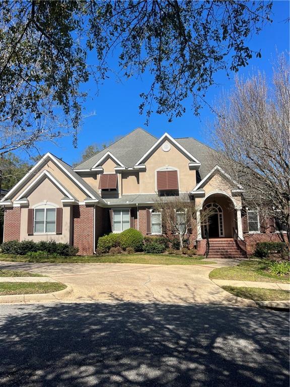 traditional-style house with stucco siding and brick siding