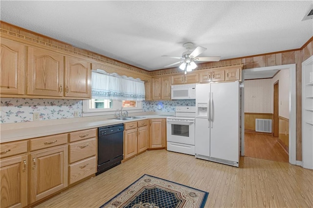 kitchen with white appliances, light brown cabinetry, sink, and light wood-type flooring