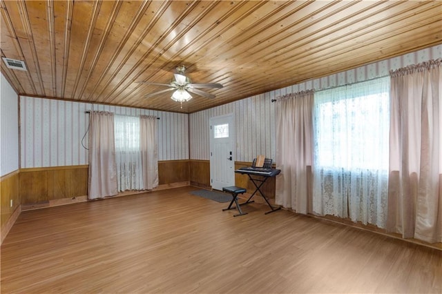 interior space with wood ceiling, ceiling fan, a healthy amount of sunlight, and light hardwood / wood-style floors