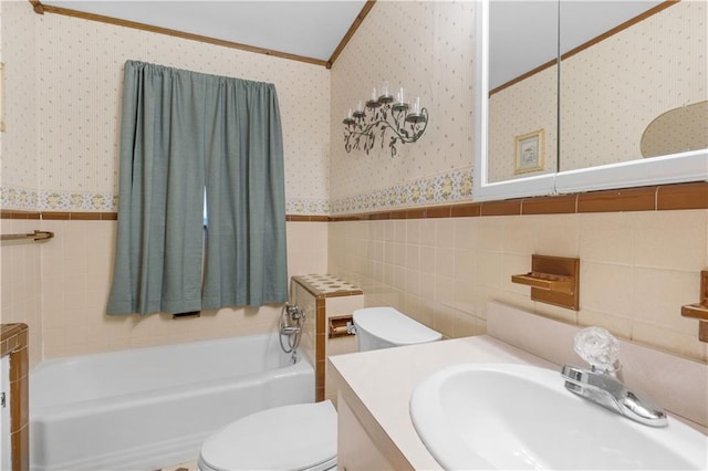 bathroom with crown molding, tile walls, vanity, a tub, and toilet