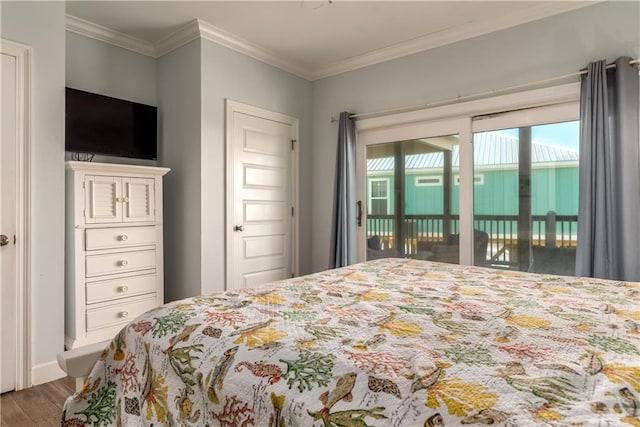 bedroom featuring access to outside, ornamental molding, and wood finished floors