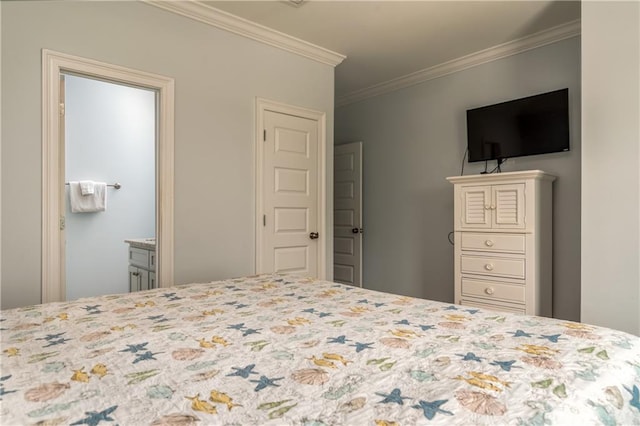 bedroom featuring ornamental molding and ensuite bathroom