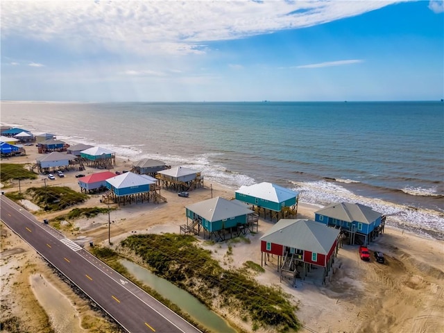 bird's eye view featuring a water view and a beach view