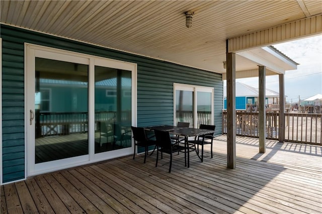 wooden deck with outdoor dining space