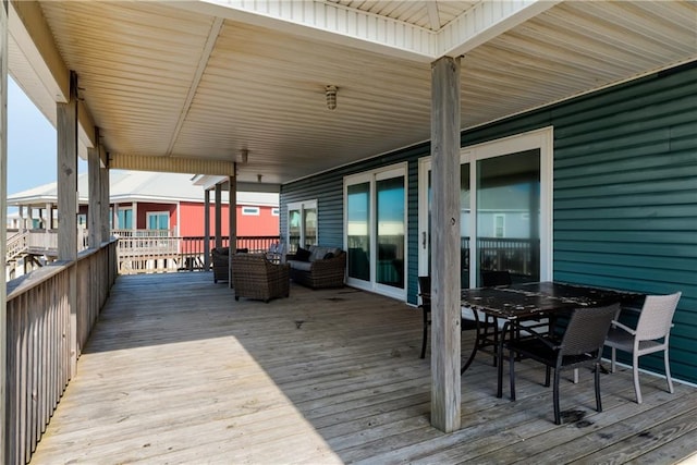 wooden terrace featuring outdoor dining space and an outdoor living space