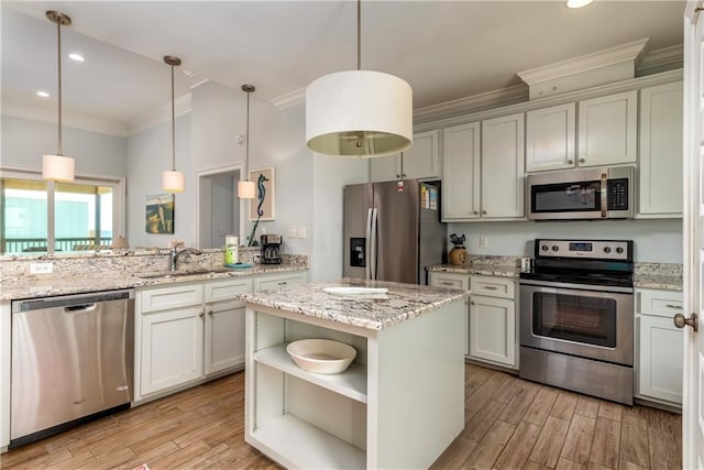 kitchen featuring open shelves, appliances with stainless steel finishes, hanging light fixtures, and a kitchen island