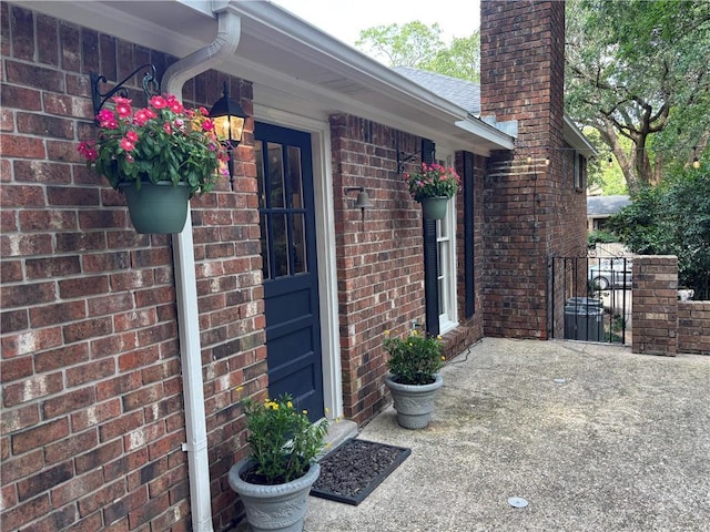 5911 Shenandoah Rd N, Mobile, AL 36608 - view of exterior entry featuring brick siding and a chimney