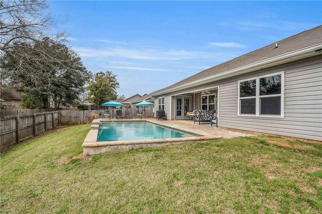 view of swimming pool with a fenced in pool, a patio area, a fenced backyard, and a yard