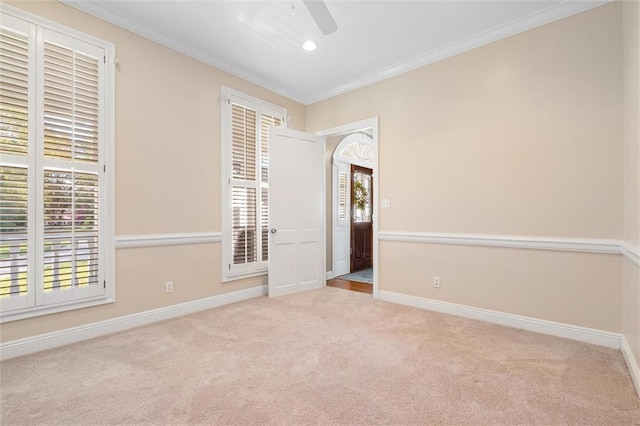 carpeted empty room with a ceiling fan, crown molding, baseboards, and recessed lighting