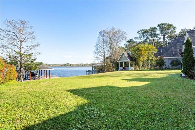 view of yard featuring a water view and a gazebo
