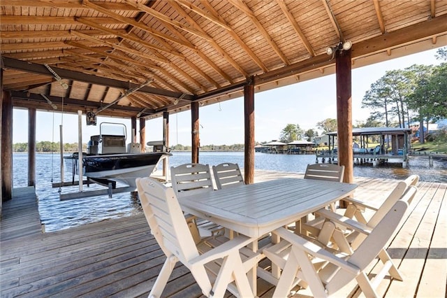 dock area with boat lift and a water view