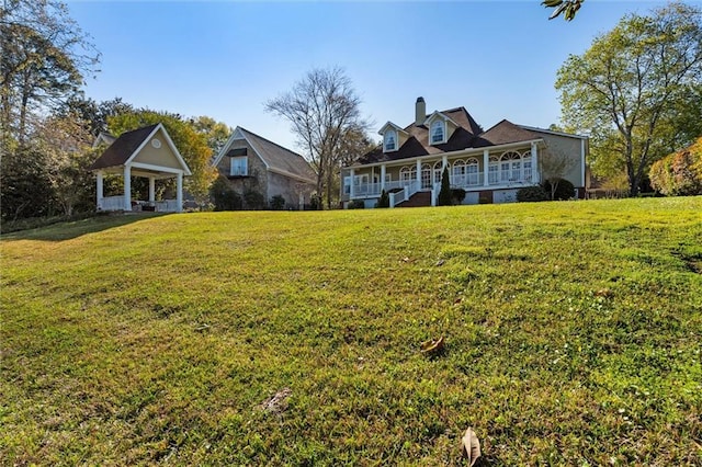 view of front of property featuring covered porch, a front yard, and a gazebo