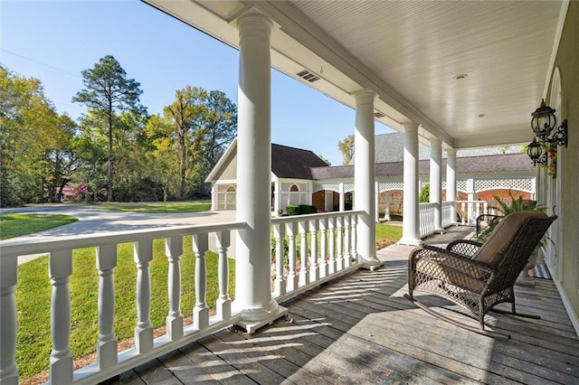 deck with visible vents and a porch