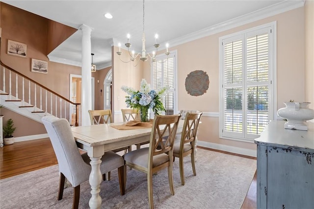 dining space featuring ornamental molding, light wood-style floors, and a wealth of natural light