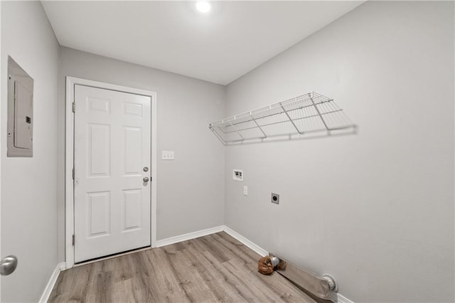 laundry area with electric panel, light hardwood / wood-style flooring, and electric dryer hookup