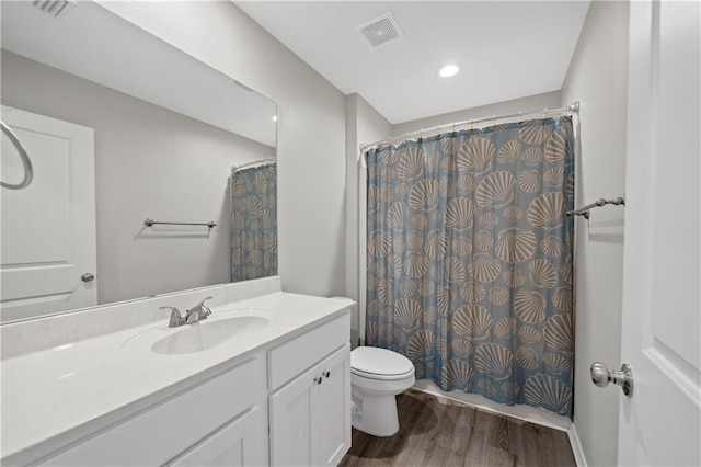 bathroom with a shower with curtain, vanity, toilet, and wood-type flooring