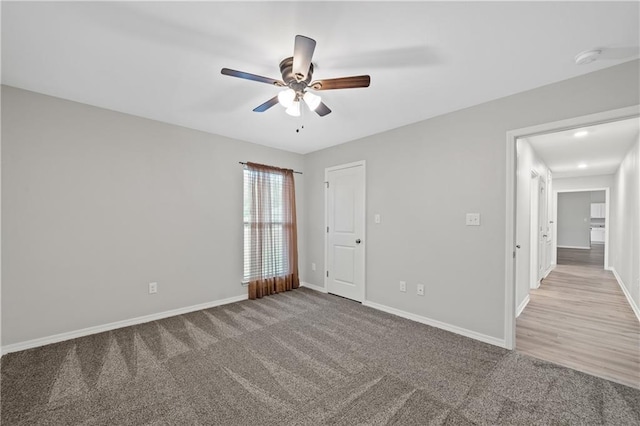 carpeted empty room with ceiling fan