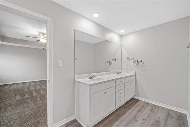 bathroom featuring ceiling fan, hardwood / wood-style floors, and vanity