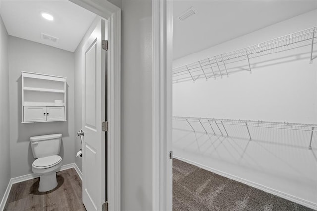 bathroom featuring hardwood / wood-style floors and toilet