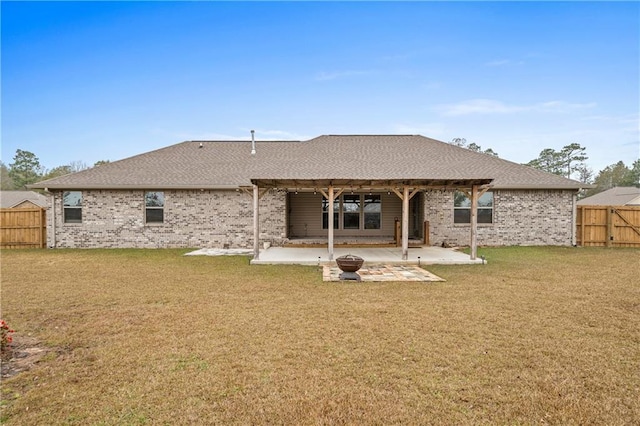 back of property with a patio and a lawn