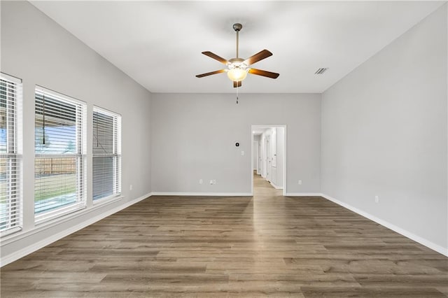 empty room featuring hardwood / wood-style flooring and ceiling fan