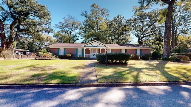 view of front of home with covered porch and a front lawn