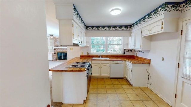 kitchen featuring white cabinets, a sink, stainless steel range with electric stovetop, dishwasher, and a peninsula