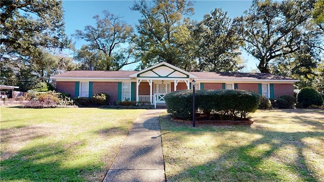 ranch-style home featuring covered porch, a front lawn, and brick siding