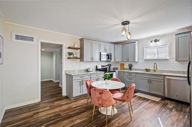 54 Bishop Ln, Mobile, AL 36608 - kitchen featuring gray cabinetry, stainless steel appliances, a sink, dark wood finished floors, and ornamental molding