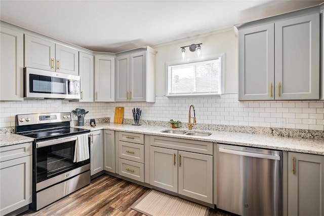 54 Bishop Ln, Mobile, AL 36608 - kitchen featuring stainless steel appliances, a sink, gray cabinetry, tasteful backsplash, and ornamental molding