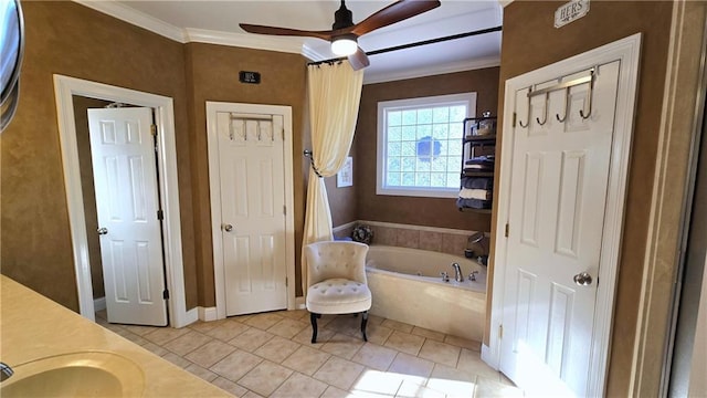 full bath with tile patterned flooring, a garden tub, a ceiling fan, and ornamental molding