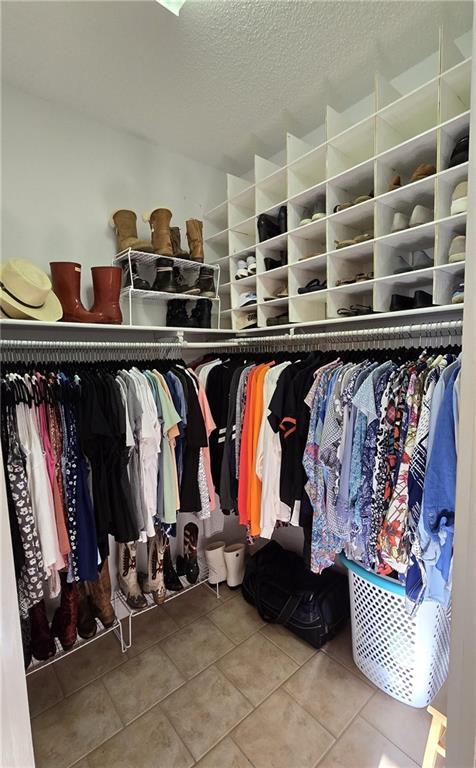 spacious closet featuring tile patterned floors