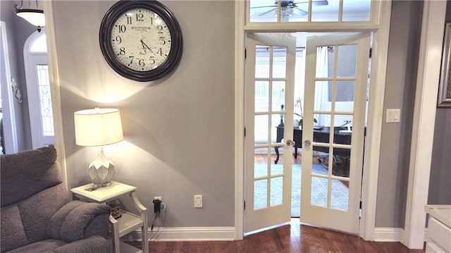 interior space featuring french doors, baseboards, and dark wood finished floors