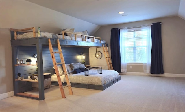 bedroom featuring baseboards, carpet floors, and vaulted ceiling