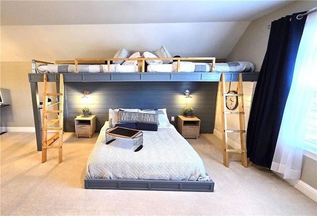 bedroom featuring vaulted ceiling, baseboards, and light carpet