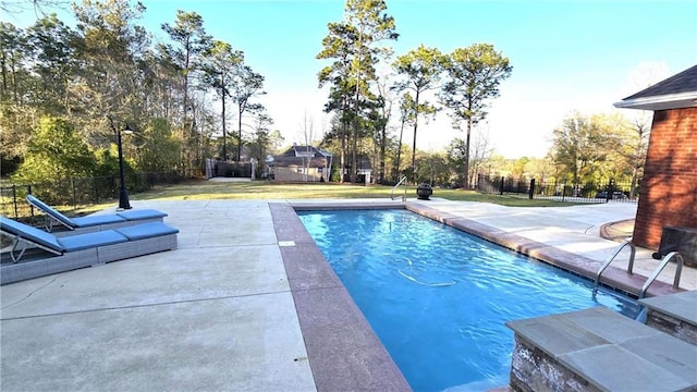 view of pool featuring a yard, a fenced in pool, a patio, and fence