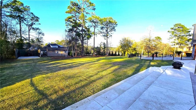 view of yard featuring a patio area, fence, and an outdoor fire pit