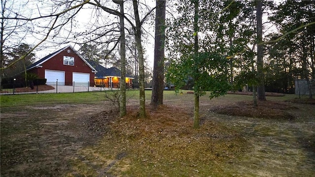 view of yard featuring an outbuilding and fence