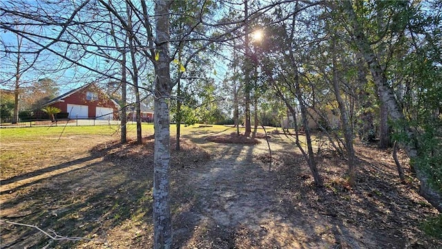 view of yard with an outbuilding and fence