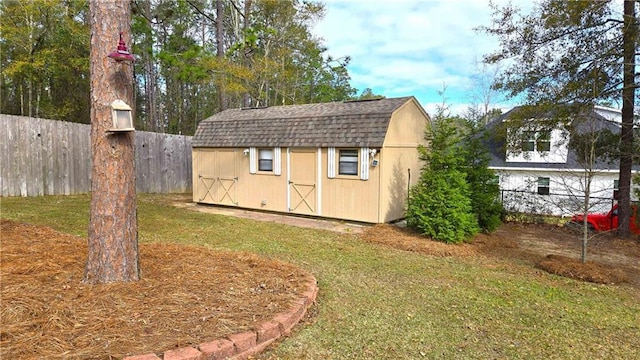 view of shed featuring fence