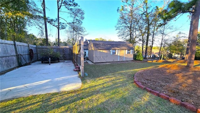 rear view of house featuring an outbuilding, a yard, a fenced backyard, a storage shed, and a patio area