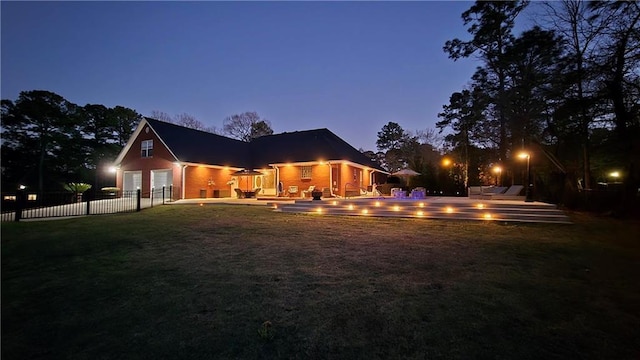 exterior space with a garage, a patio, a yard, and fence