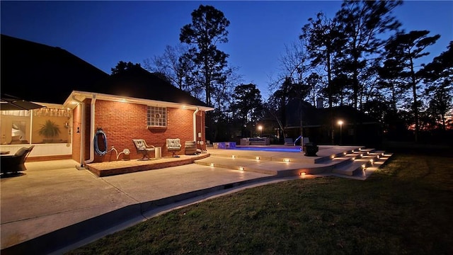 exterior space with an outdoor pool and a yard