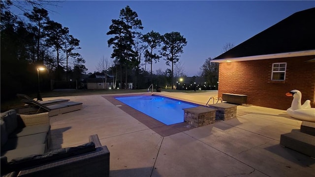 outdoor pool with a patio area