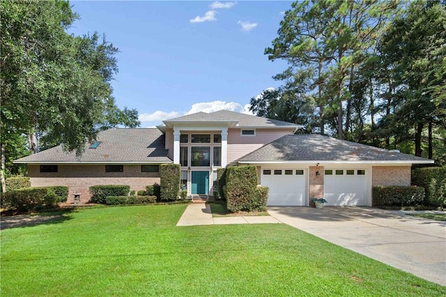 110 Schooley Cir, Daphne, AL 36526 - view of front of house featuring a garage, driveway, a front yard, and brick siding