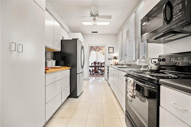 110 Schooley Cir, Daphne, AL 36526 - kitchen with black appliances, ceiling fan, a sink, white cabinets, and light tile patterned floors