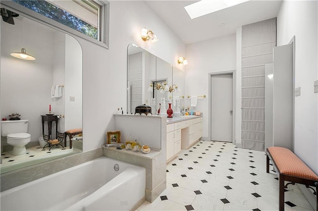 110 Schooley Cir, Daphne, AL 36526 - bathroom with a skylight, a bath, vanity, toilet, and tile patterned floors