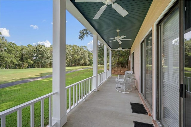 110 Schooley Cir, Daphne, AL 36526 - covered porch with ceiling fan, a lawn, and view of wooded area